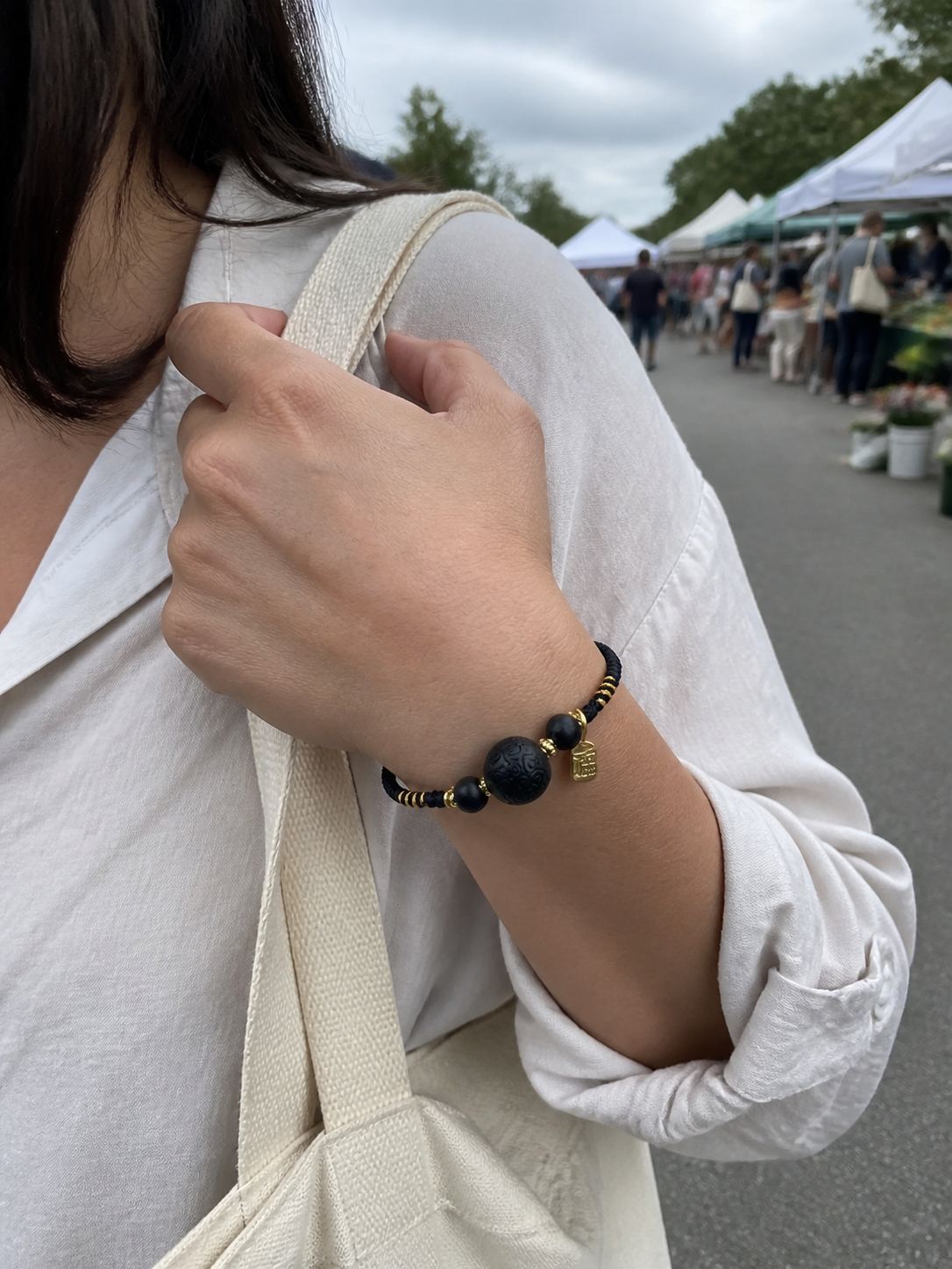 Western woman wearing an adjustable black cord incense bracelet