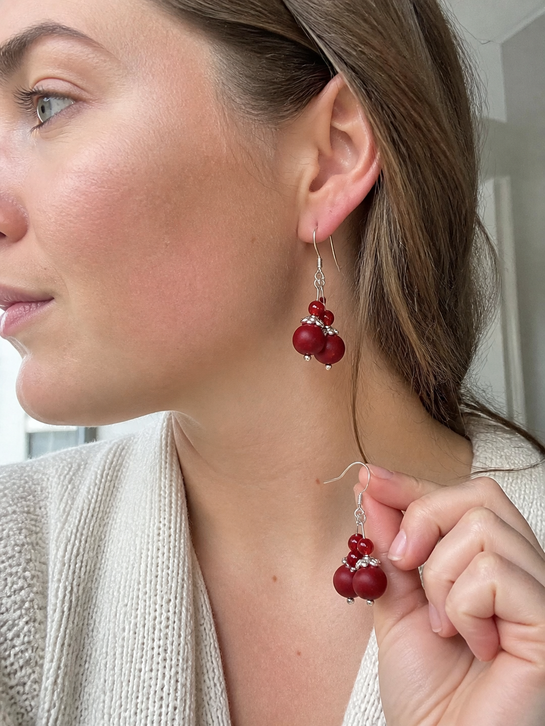 Western woman wearing red incense bead earrings